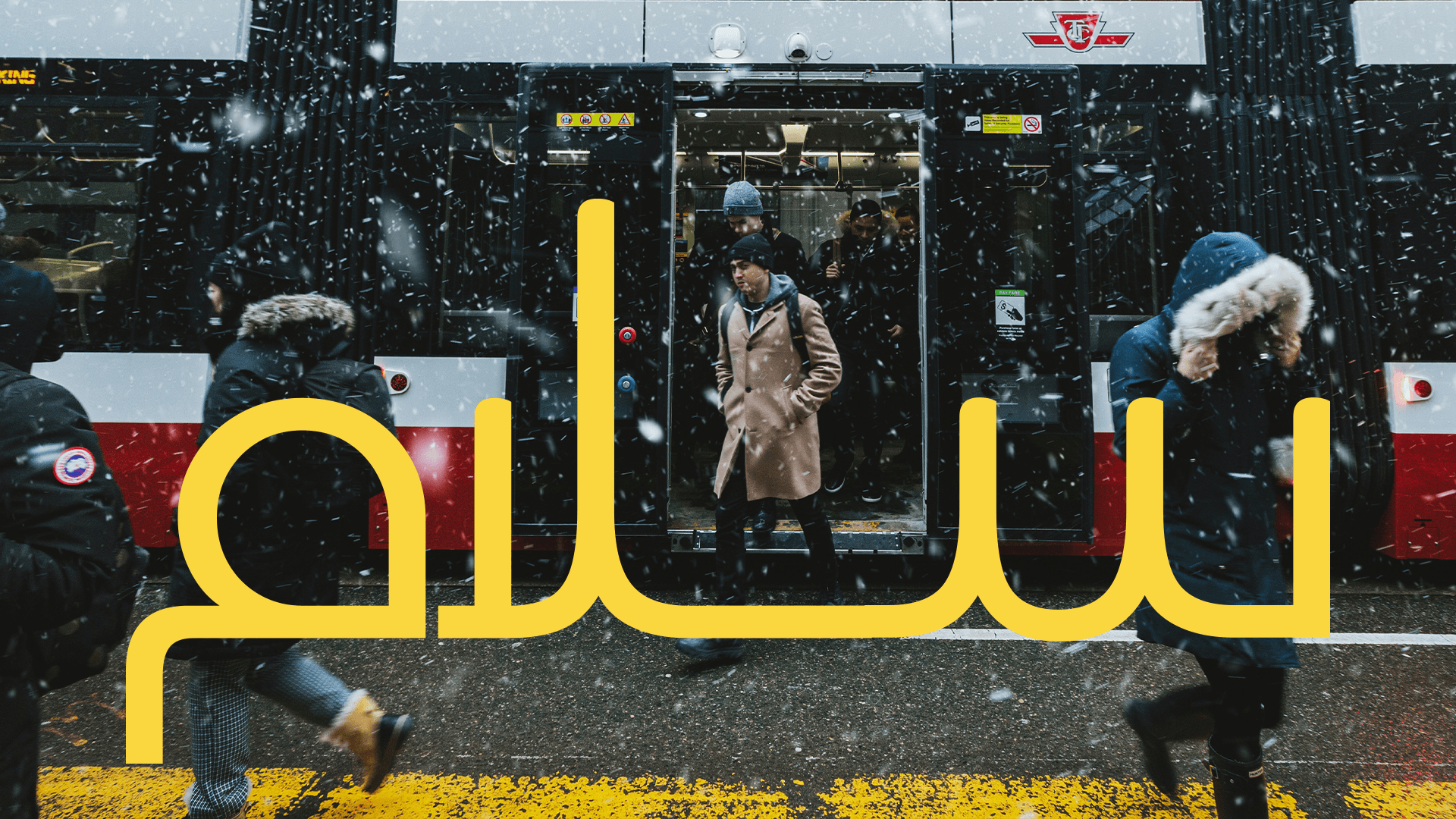 The Salaam wordmark over a Toronto TTC streetcar in falling snow.